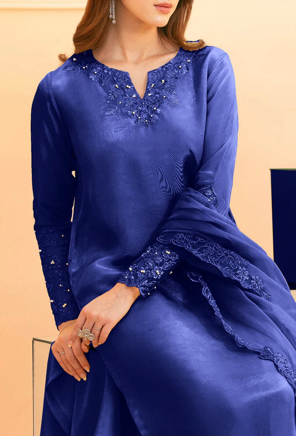 Royal blue palazzo suit by Armas featuring intricate lace and sequin detailing on the neckline and cuffs.